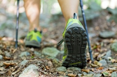 Woman exercising in forest, nordic walking